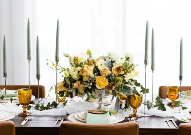 Flowers in a vase on a table with candles