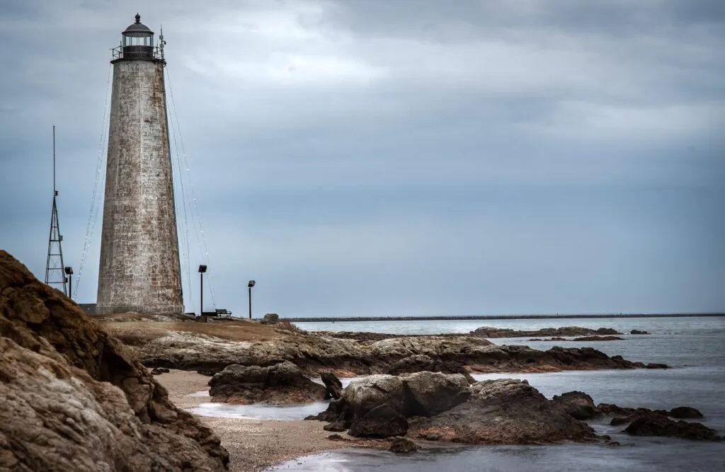 Lighthouse with the ocean and rocks